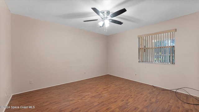 spare room featuring hardwood / wood-style flooring and ceiling fan