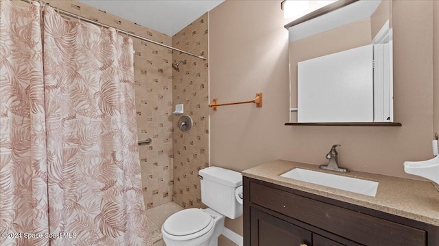 bathroom with toilet, vanity, and a shower with shower curtain