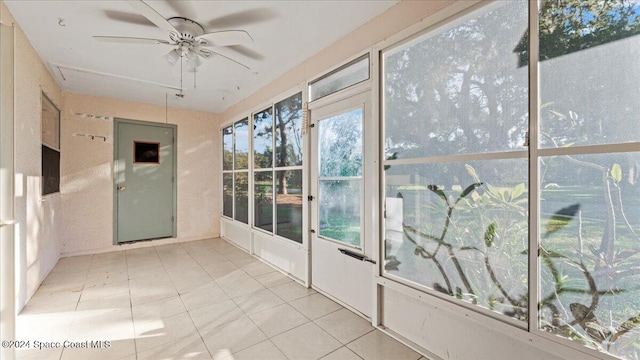 unfurnished sunroom featuring ceiling fan