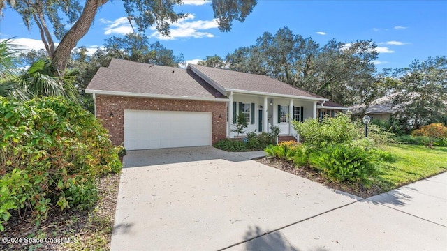 single story home with a porch and a garage