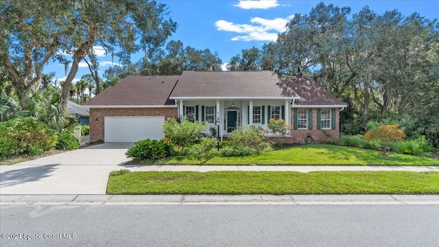 ranch-style home featuring a front lawn and a garage