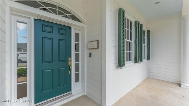 view of exterior entry with a porch