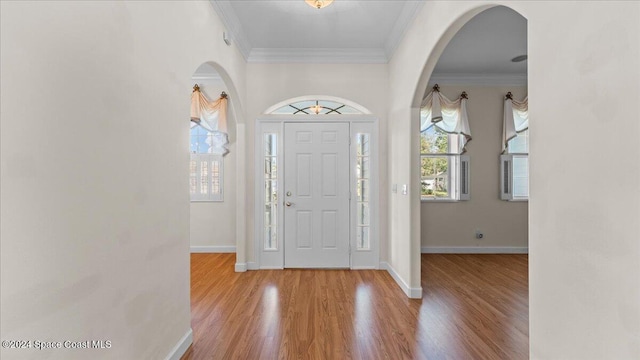 foyer featuring ornamental molding and hardwood / wood-style flooring