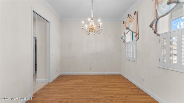 unfurnished dining area with a notable chandelier, light hardwood / wood-style floors, and crown molding