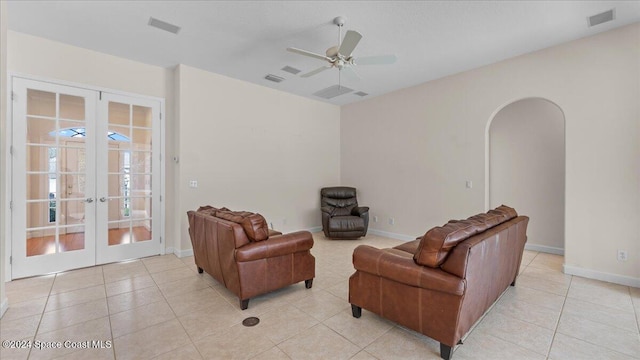 tiled living room with french doors and ceiling fan