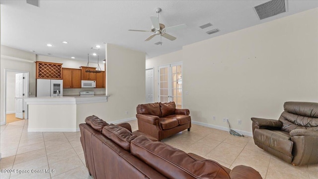 tiled living room with ceiling fan