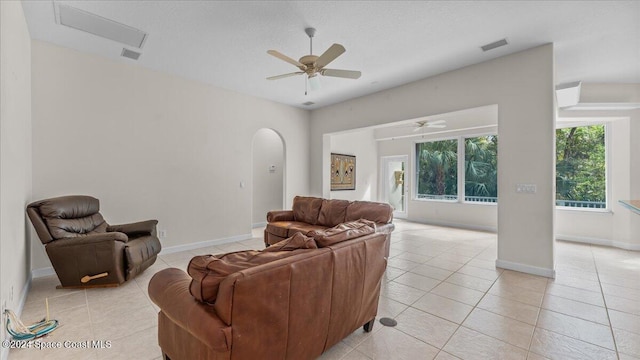 tiled living room with ceiling fan