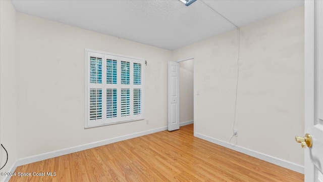 spare room with light hardwood / wood-style floors