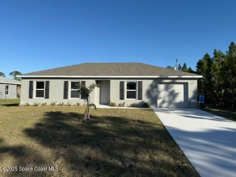 ranch-style home featuring a garage and a front lawn