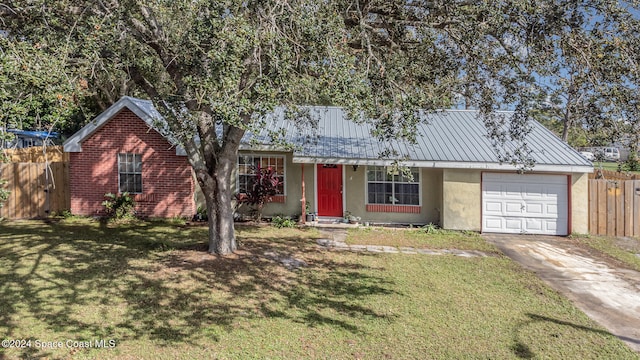 view of front of property featuring a garage and a front yard