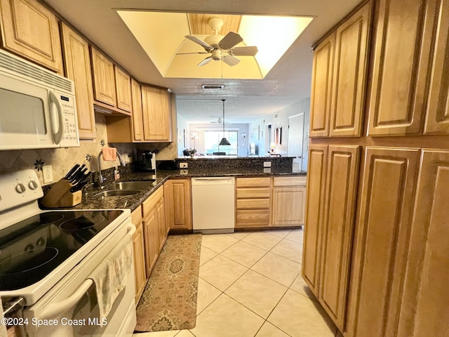 kitchen with white appliances, kitchen peninsula, ceiling fan, decorative light fixtures, and light tile patterned floors