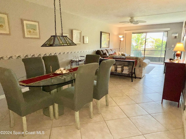 dining area with light tile patterned floors and ceiling fan