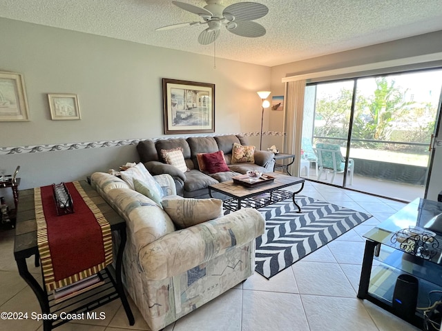 tiled living room with ceiling fan and a textured ceiling