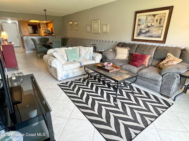 living room featuring light tile patterned flooring and a textured ceiling