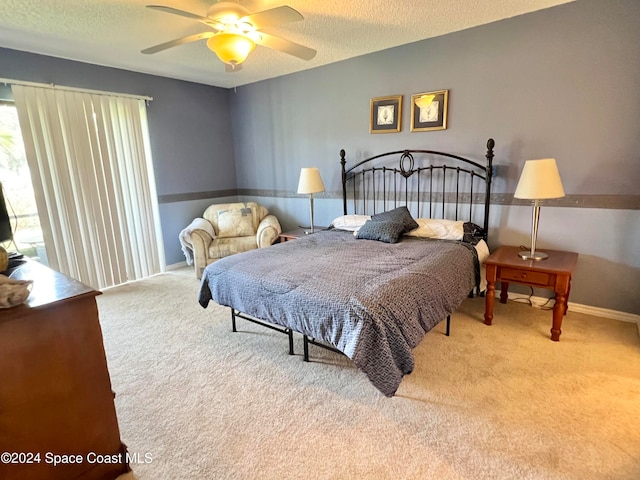 carpeted bedroom with a textured ceiling and ceiling fan