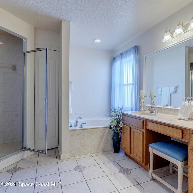 bathroom featuring tile patterned flooring, a textured ceiling, vanity, and separate shower and tub