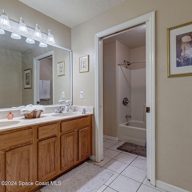 bathroom featuring a textured ceiling, tile patterned flooring, vanity, and  shower combination