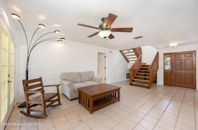 living room with light tile patterned floors and ceiling fan