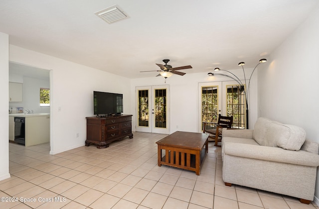 tiled living room featuring french doors, a wealth of natural light, and ceiling fan