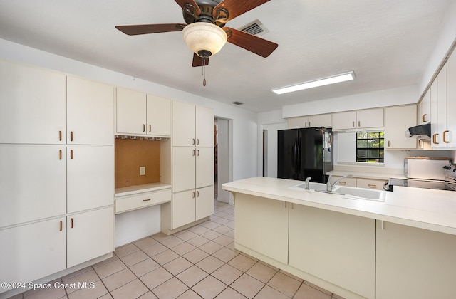 kitchen with black fridge, extractor fan, stove, sink, and ceiling fan