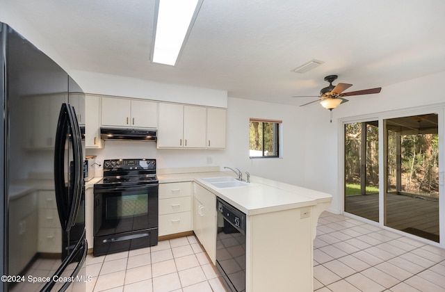 kitchen with kitchen peninsula, black appliances, sink, light tile patterned floors, and ceiling fan