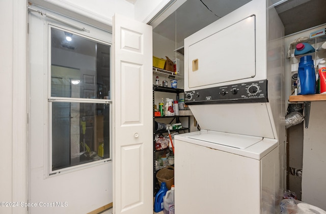 laundry room with stacked washer / drying machine