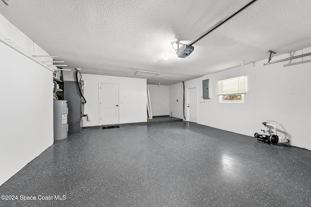 garage with a garage door opener, electric panel, and electric water heater