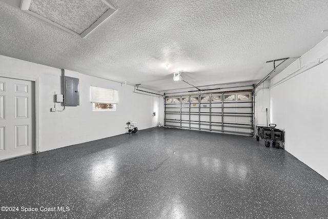 garage with a garage door opener and electric panel