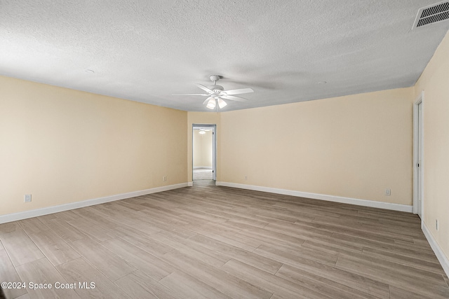 unfurnished room with ceiling fan, a textured ceiling, and light hardwood / wood-style floors