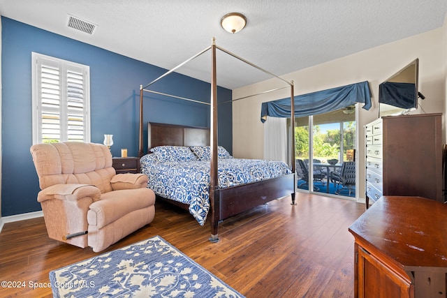 bedroom with dark wood-type flooring, access to outside, and multiple windows