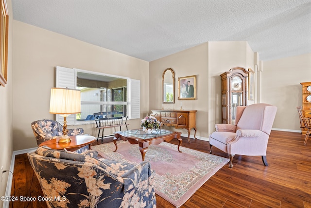 living room with a textured ceiling, wood-type flooring, and a wealth of natural light