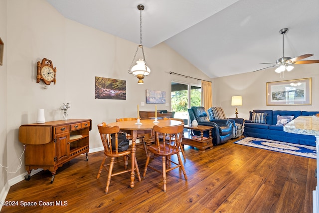 dining area featuring lofted ceiling, wood-type flooring, and ceiling fan