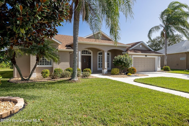 ranch-style house featuring a front yard and a garage