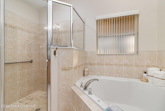 bathroom featuring plus walk in shower