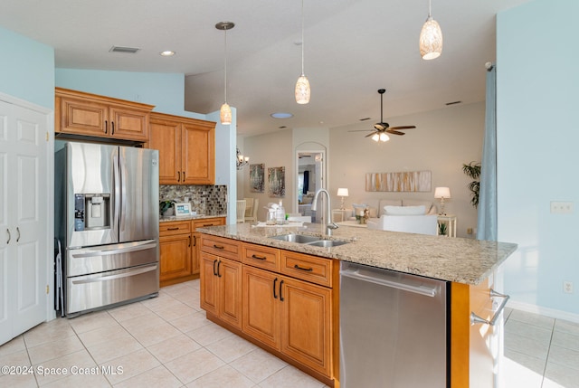 kitchen with sink, vaulted ceiling, ceiling fan, an island with sink, and stainless steel appliances