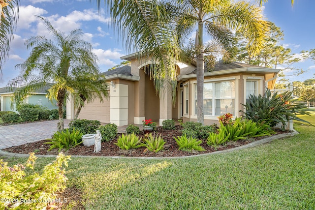 view of front of house with a garage and a front yard