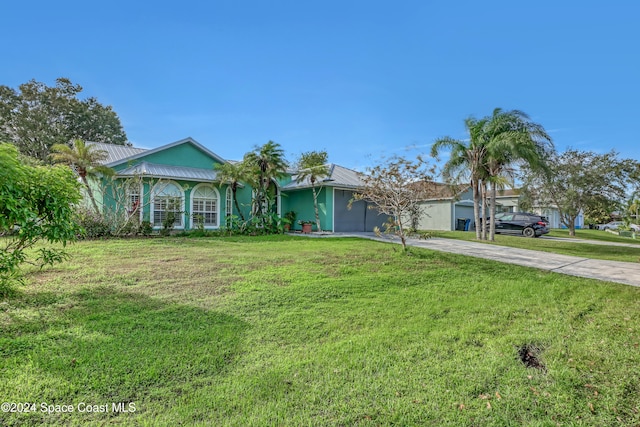 single story home with a front yard and a garage