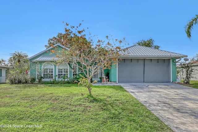 view of front of house with a front lawn and a garage