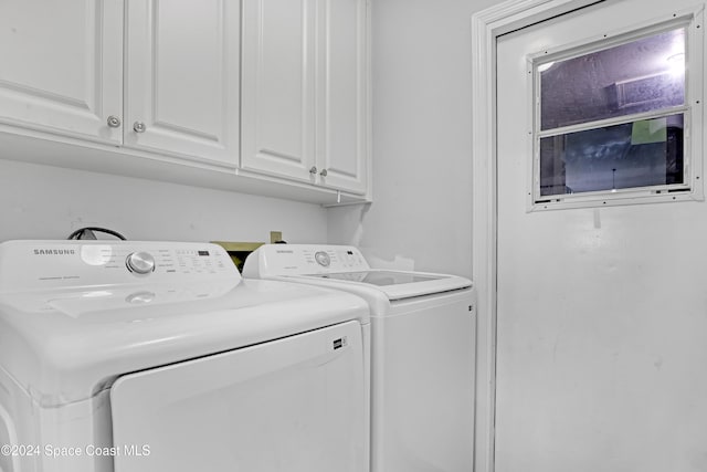 laundry room with cabinets and washer and clothes dryer