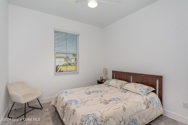 bedroom with ceiling fan and light carpet