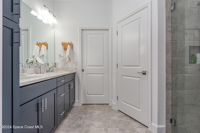 bathroom with vanity, tile patterned flooring, and a shower with door