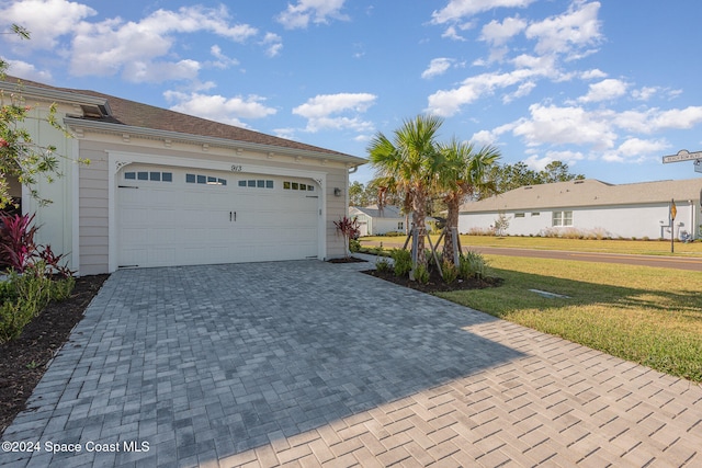 exterior space featuring a front yard and a garage