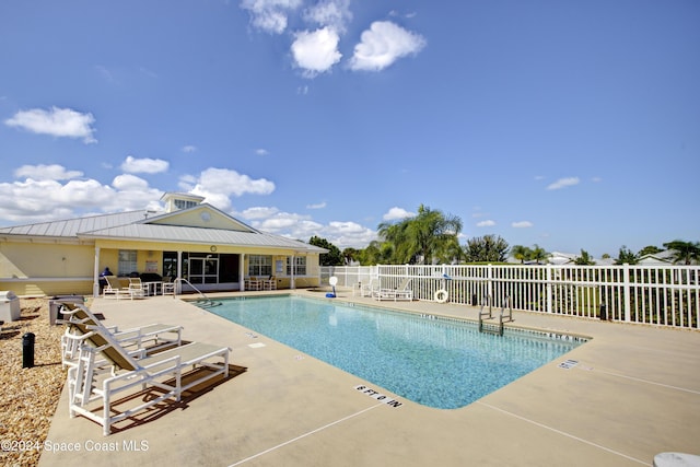 pool with fence and a patio area