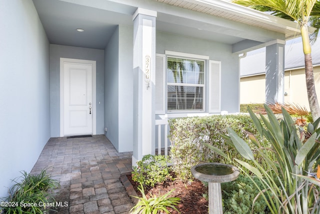 doorway to property with stucco siding