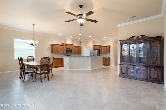 kitchen featuring brown cabinets, ceiling fan with notable chandelier, stainless steel appliances, decorative backsplash, and visible vents