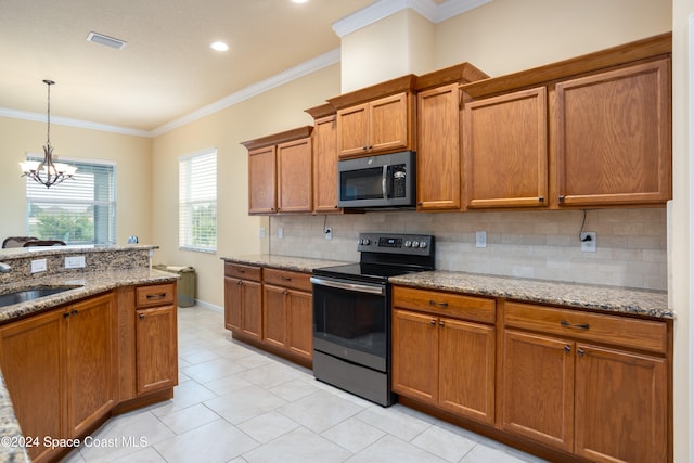 kitchen featuring light stone countertops, crown molding, appliances with stainless steel finishes, and an inviting chandelier