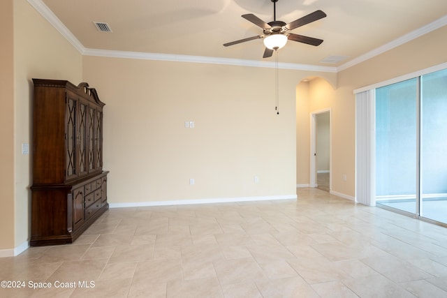 unfurnished living room with visible vents, arched walkways, ceiling fan, and crown molding