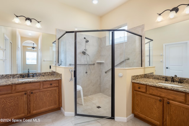 bathroom with vanity, ceiling fan, tile patterned flooring, and walk in shower