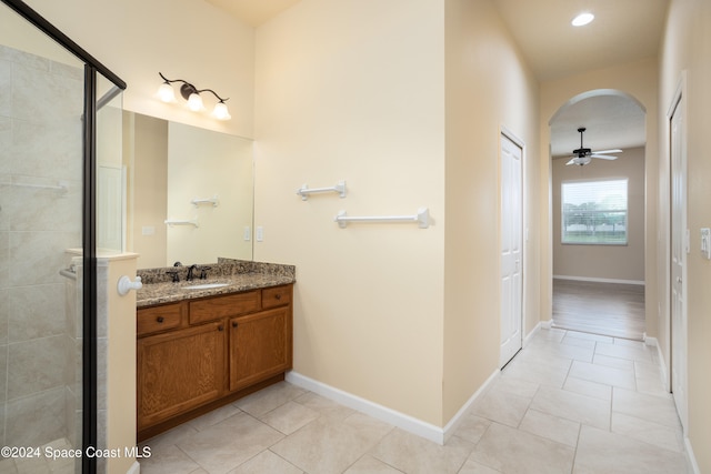 bathroom with vanity, ceiling fan, tile patterned floors, and walk in shower