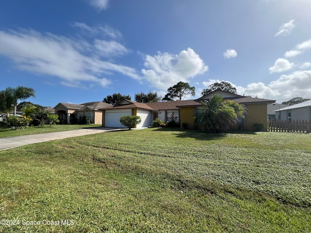 single story home featuring a front yard and a garage